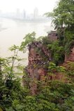 The Leshan Giant Buddha (Lèshān Dàfó) was built during the Tang Dynasty (618–907AD). It is carved out of a cliff face that lies at the confluence of the Minjiang, Dadu and Qingyi rivers in the southern part of Sichuan province in China, near the city of Leshan. The stone sculpture faces Mount Emei, with the rivers flowing below his feet. It is the largest carved stone Buddha in the world and at the time of its construction was the tallest statue in the world.