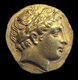 Head of Apollo on a gold stater coin struck by Philip II of Macedon (r.359-336 BCE).<br/><br/>

Apollo is one of the most important and diverse of the Olympian deities in Greek and Roman mythology. The ideal of the kouros (a beardless, athletic youth), Apollo has been variously recognized as a god of light and the sun; truth and prophecy; medicine, healing, and plague; music, poetry, and the arts; and more.<br/><br/>

Apollo is the son of Zeus and Leto, and has a twin sister, the chaste huntress Artemis. Apollo is known in Greek-influenced Etruscan mythology as Apulu. Apollo was worshiped in both ancient Greek and Roman religion, as well as in the modern Greco–Roman Neopaganism.